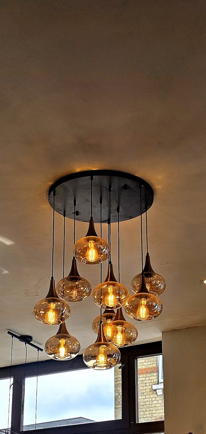 Amber pendant bulbs above the tables